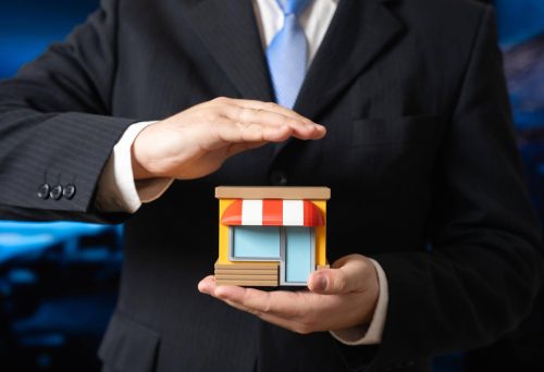 A man protects a store in his hands support for small businesses and entrepreneurship